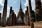 Thailand, Old Sukhothai - Wat Sa Si. Main chedi in Singhalese style with in front the viharn with a sitting Buddha statue. 